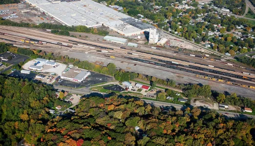Aerial view of a railroad and forest landscape