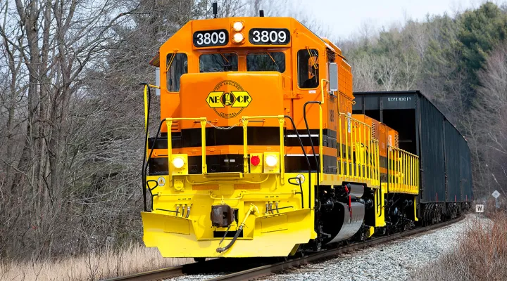 Front view of a train pulling freight railcar