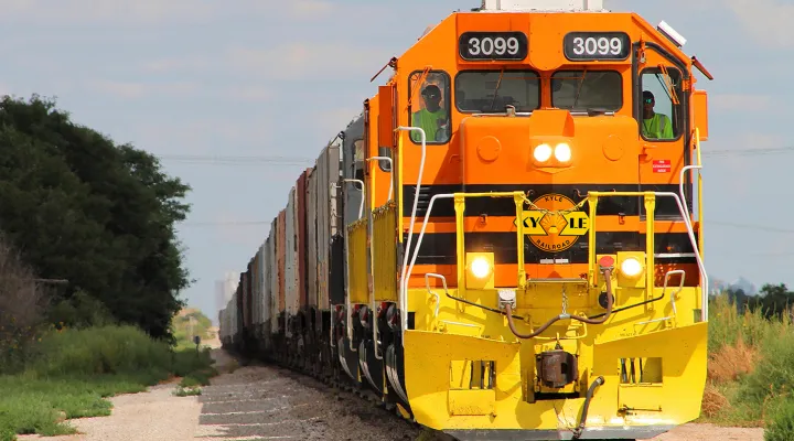 Front view of a train pulling freight railcars