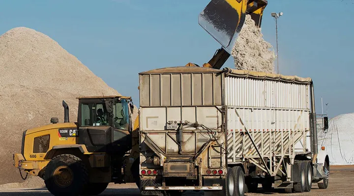 Raw materials being transferred into a freight railcar