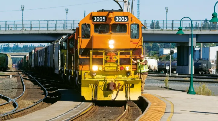 Front view of a train pulling freight railcars 